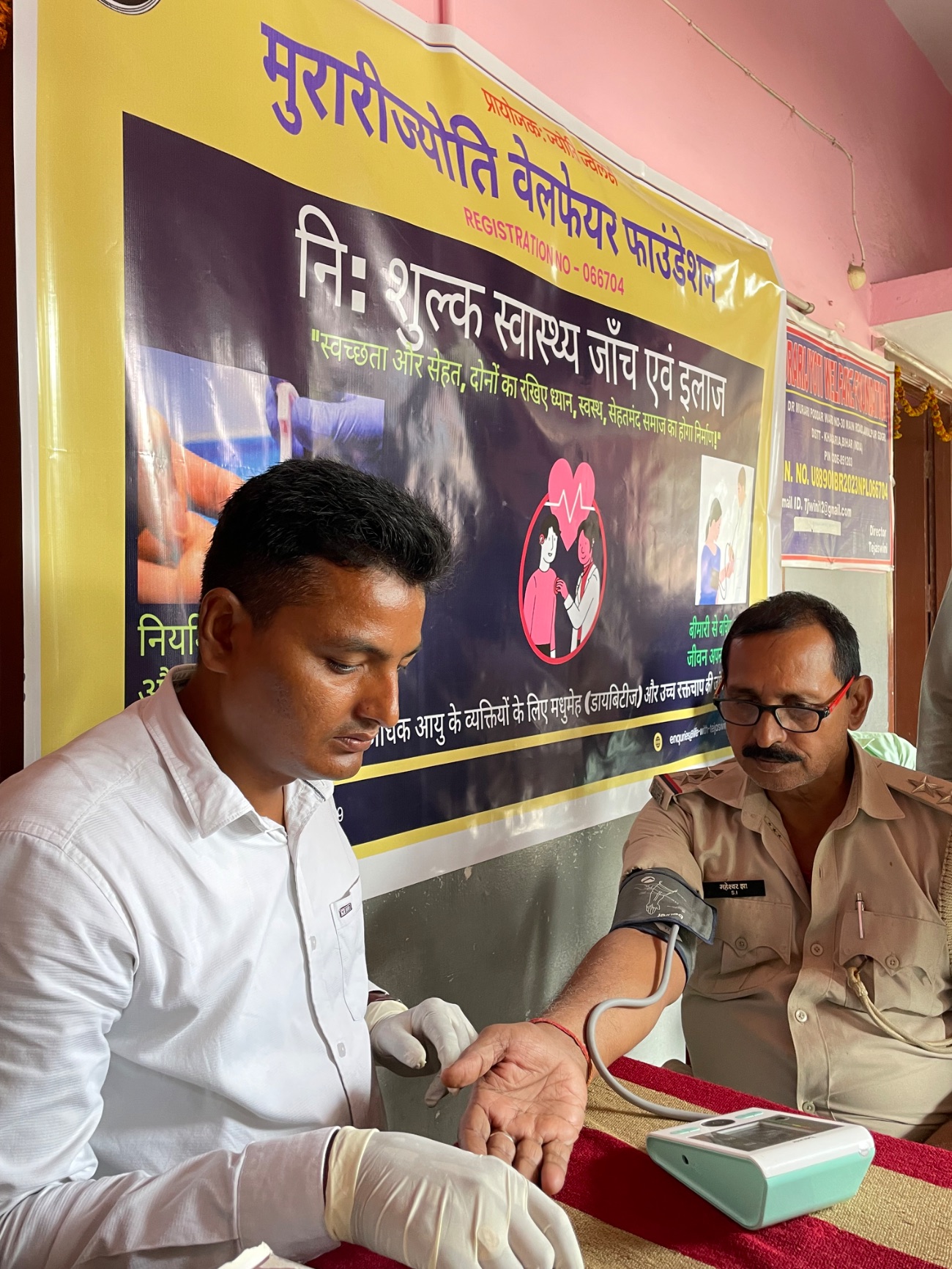 A police officer has his blood pressure checked at a free MJWF community health camp.