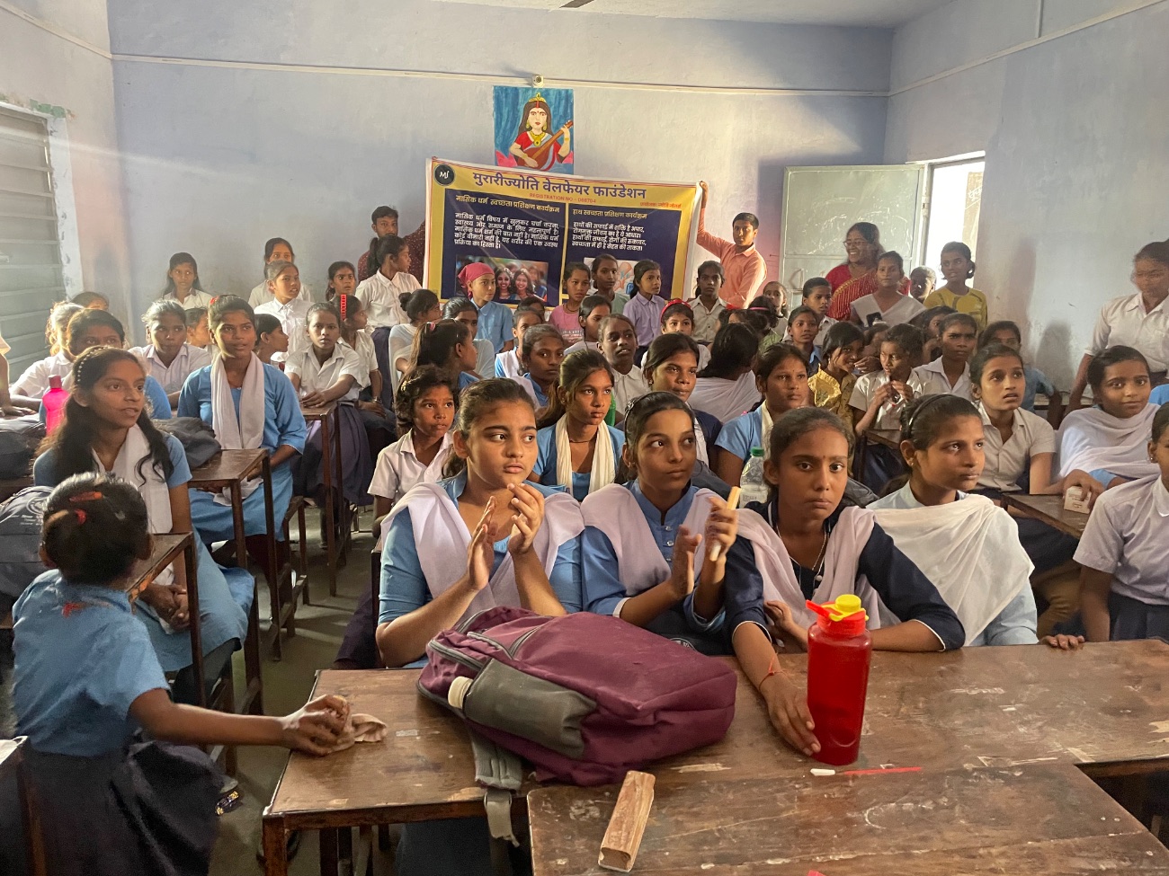 Schoolgirls listen during an MJWF classroom session on health and hygiene.